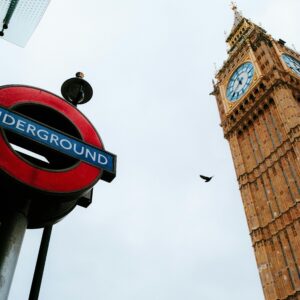 Iconic view of London's Big Ben and Underground sign on an overcast day, capturing the essence of the city.
