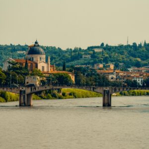Captivating view of Verona's historic bridge and cathedral, highlighting Italy's architectural charm.