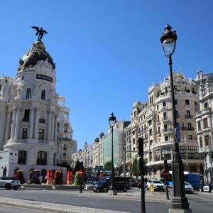 Iconic Metropolis Building on Gran Vía in Madrid under a clear blue sky.
